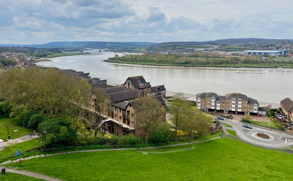 A photograph taken from the top of Churchfields, showing the bank alongside the steps, and beyond, the River Medway curving away to the Medway Viaducts