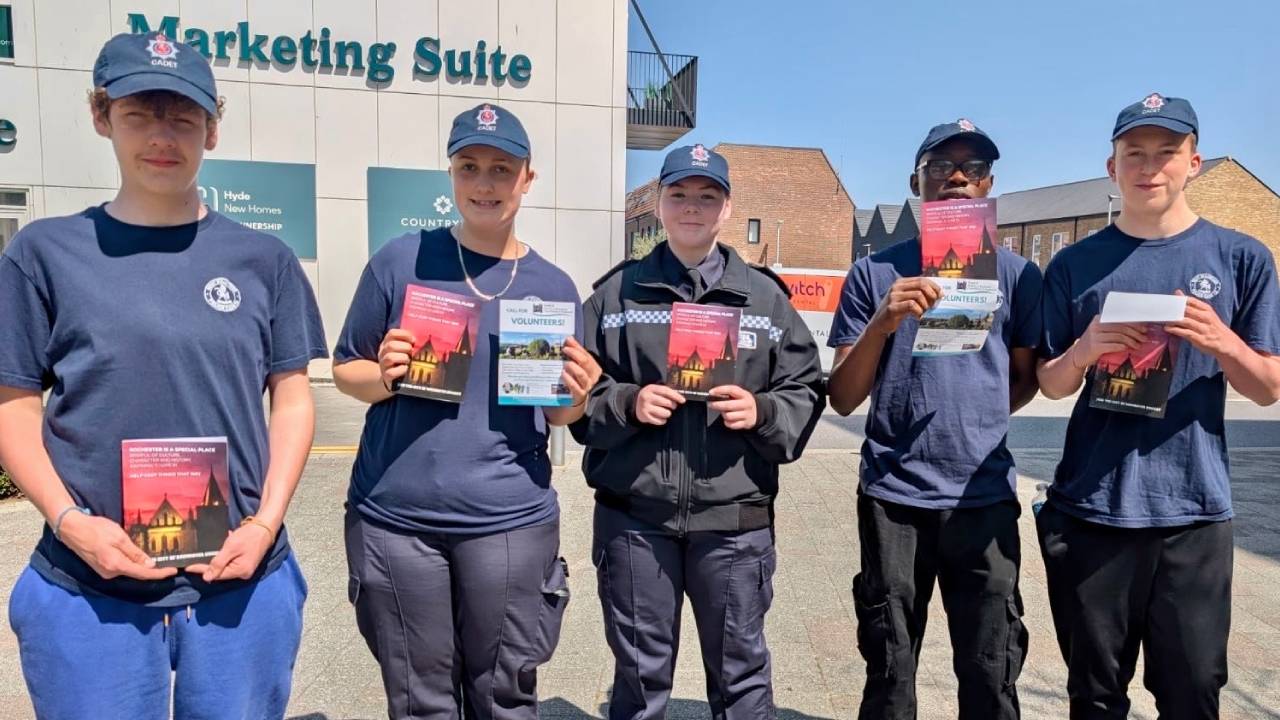 Five police cadets at Rochester Riverside holding the leaflets they helped us deliver