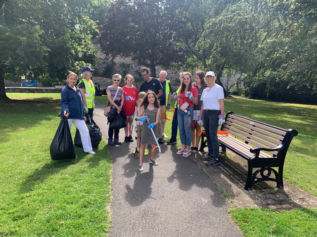 Volunteers of all ages pose for a photo after a productive litter picking session
